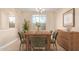 Bright dining room with a wooden table, chandelier, and large window, perfect for gatherings at 263 W Rosemary Dr, Chandler, AZ 85248