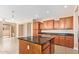 Gourmet kitchen featuring an island, tile flooring, dark countertops and view to the backyard at 263 W Rosemary Dr, Chandler, AZ 85248