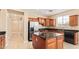 Modern kitchen featuring stainless steel appliances, a granite-topped island, and ample counter space with tile flooring at 263 W Rosemary Dr, Chandler, AZ 85248