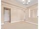 Open-concept living area with neutral walls, tile floors, ample natural light, and view to hallway at 263 W Rosemary Dr, Chandler, AZ 85248