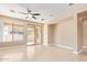 Spacious living area featuring tile flooring, a ceiling fan, and sliding glass doors to the patio at 263 W Rosemary Dr, Chandler, AZ 85248