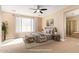 Serene main bedroom with large window, ceiling fan, ensuite bathroom and walk-in shower at 263 W Rosemary Dr, Chandler, AZ 85248