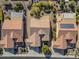 Aerial view of three homes with solar panels and landscaped yards at 26335 W Burnett Rd, Buckeye, AZ 85396