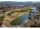 Aerial view of a golf course with lake and mountains in background at 26335 W Burnett Rd, Buckeye, AZ 85396