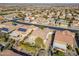 Aerial view showcasing a neighborhood with houses featuring solar panels and lush landscaping at 26335 W Burnett Rd, Buckeye, AZ 85396