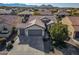 Aerial view of a house with a two-car garage and nicely landscaped front yard at 26335 W Burnett Rd, Buckeye, AZ 85396