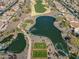 Aerial view of community with lake, golf course, and homes at 26335 W Burnett Rd, Buckeye, AZ 85396