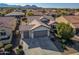 Aerial view of a house with a two-car garage and nicely landscaped front yard at 26335 W Burnett Rd, Buckeye, AZ 85396