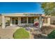 Covered patio, seating area, and desert landscaping at 26335 W Burnett Rd, Buckeye, AZ 85396