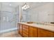 Bathroom with double vanity, large shower, and tile floor at 26335 W Burnett Rd, Buckeye, AZ 85396