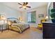 Bright bedroom with a ceiling fan and large window at 26335 W Burnett Rd, Buckeye, AZ 85396