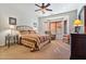 Primary bedroom with bay window, ceiling fan, and dresser at 26335 W Burnett Rd, Buckeye, AZ 85396
