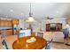 Open dining area with a round table, adjacent to kitchen and living room at 26335 W Burnett Rd, Buckeye, AZ 85396