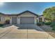 Two-car garage and front entry of home at 26335 W Burnett Rd, Buckeye, AZ 85396