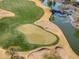 Aerial view of a putting green next to a lake at 26335 W Burnett Rd, Buckeye, AZ 85396