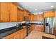 Spacious kitchen boasts stainless steel appliances and wood cabinetry at 26335 W Burnett Rd, Buckeye, AZ 85396