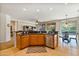 Open kitchen with island, granite counters, and stainless steel appliances at 26335 W Burnett Rd, Buckeye, AZ 85396