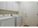 Laundry room with washer, dryer, and cabinets at 26335 W Burnett Rd, Buckeye, AZ 85396