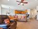 Open-concept living area with leather seating and kitchen views at 26335 W Burnett Rd, Buckeye, AZ 85396