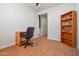 Home office with desk, chair, and bookshelf at 26335 W Burnett Rd, Buckeye, AZ 85396