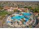 Aerial view of community pool with surrounding lounge areas and palm trees at 26335 W Burnett Rd, Buckeye, AZ 85396
