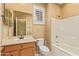 Clean bathroom with tub, shower, and wood vanity at 2927 W Plum Hollow Dr, Anthem, AZ 85086
