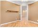 Bedroom with wood flooring, shelf, and access to another room at 2927 W Plum Hollow Dr, Anthem, AZ 85086