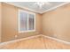 Light and airy bedroom with wood flooring and window shutters at 2927 W Plum Hollow Dr, Anthem, AZ 85086