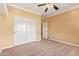 Well-lit bedroom with double door closet and neutral carpeting at 2927 W Plum Hollow Dr, Anthem, AZ 85086