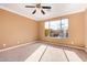 Spacious bedroom with large window and carpet flooring at 2927 W Plum Hollow Dr, Anthem, AZ 85086