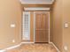 Interior entry with wood door and tile flooring at 2927 W Plum Hollow Dr, Anthem, AZ 85086