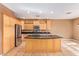 Kitchen with island, granite countertops, and wood cabinets at 2927 W Plum Hollow Dr, Anthem, AZ 85086