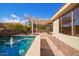 Relaxing pool area with a pergola, stonework, and lush landscaping at 2927 W Plum Hollow Dr, Anthem, AZ 85086