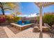 Private backyard spa with stonework and a pergola for shade at 2927 W Plum Hollow Dr, Anthem, AZ 85086