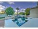 Outdoor pool area featuring a stone water feature, built-in barbecue, and lush landscaping for relaxation at 300 N Portland Ave, Gilbert, AZ 85234