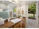Bathroom features a granite countertop, mirror, and a door to the patio at 300 N Portland Ave, Gilbert, AZ 85234