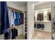 Organized walk-in closet with hanging racks, shelves, and plenty of storage space for clothes and shoes at 300 N Portland Ave, Gilbert, AZ 85234