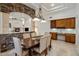 Open dining area with stone archway, stylish chandelier, and view of fireplace in living room at 300 N Portland Ave, Gilbert, AZ 85234