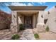 Inviting front entrance with stone accents, shade trees, and a landscaped walkway at 300 N Portland Ave, Gilbert, AZ 85234