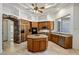 Spacious kitchen featuring a center island, granite countertops, custom cabinetry, and modern appliances at 300 N Portland Ave, Gilbert, AZ 85234