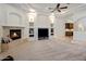 Spacious living room featuring a fireplace, built-in shelving, and a view of the adjacent bar area at 300 N Portland Ave, Gilbert, AZ 85234