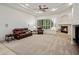Bright living room features a fireplace, a ceiling fan and a comfortable leather sofa at 300 N Portland Ave, Gilbert, AZ 85234