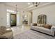 Bright living room featuring neutral tones, elegant chandeliers, and views of the front yard at 300 N Portland Ave, Gilbert, AZ 85234