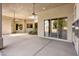 Covered patio with ceiling fans, skylight and large sliding glass doors offer seamless indoor-outdoor living at 300 N Portland Ave, Gilbert, AZ 85234