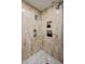 Elegant shower features dual shower heads, built-in shelving, and marble-look tile at 300 N Portland Ave, Gilbert, AZ 85234