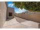 A side yard features stone ground cover, concrete sidewalk and privacy walls at 300 N Portland Ave, Gilbert, AZ 85234