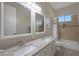 Bathroom with granite countertop, double sinks, and bathtub at 3007 S Colonial St, Gilbert, AZ 85295