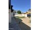 The backyard features a small artificial turf lawn, desert landscaping, a white privacy fence and paver patio at 3021 N 47Th St, Phoenix, AZ 85018