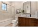 Bright bathroom featuring a shower over the tub and rustic wooden vanity at 3021 N 47Th St, Phoenix, AZ 85018