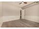 Empty bedroom with hardwood floors, wainscoting, ceiling fan and a view to an adjacent room at 3021 N 47Th St, Phoenix, AZ 85018